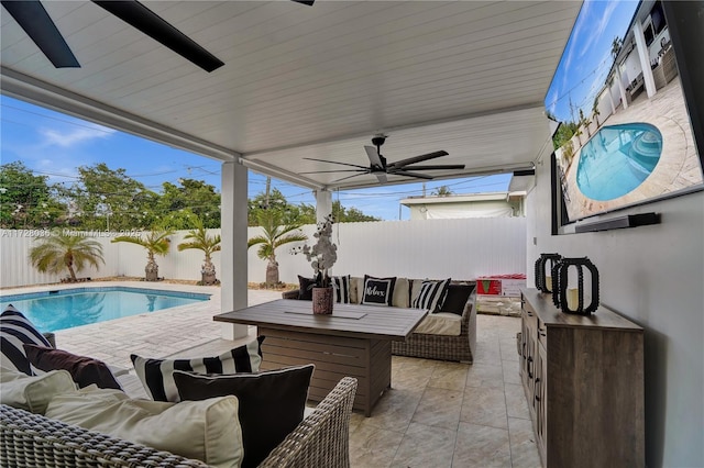 view of patio featuring a bar, ceiling fan, an outdoor hangout area, and a fenced in pool