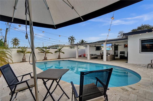 view of pool with ceiling fan, an outdoor hangout area, and a patio area