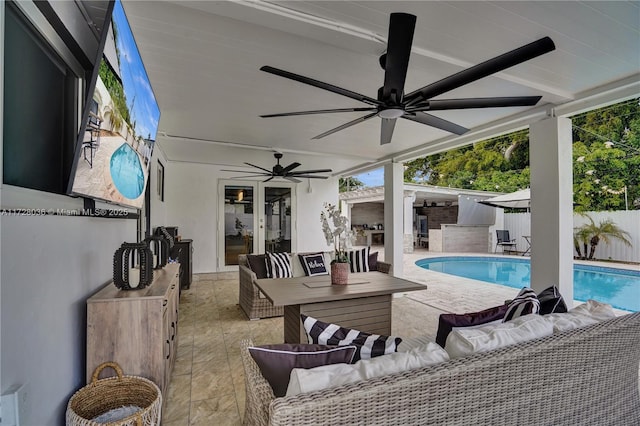 exterior space featuring a fenced in pool, an outdoor hangout area, ceiling fan, and an outdoor kitchen