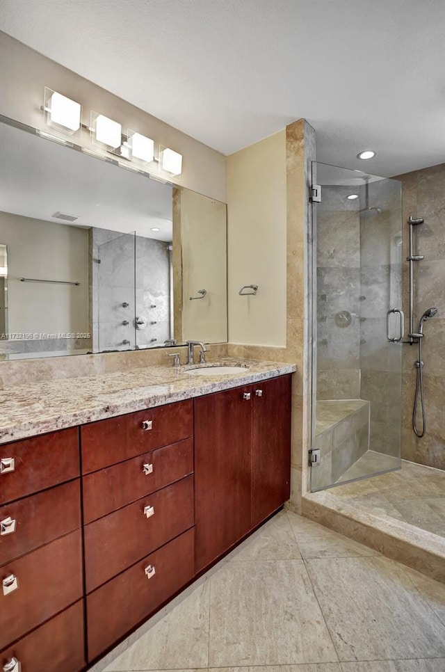 bathroom featuring vanity and a shower with shower door