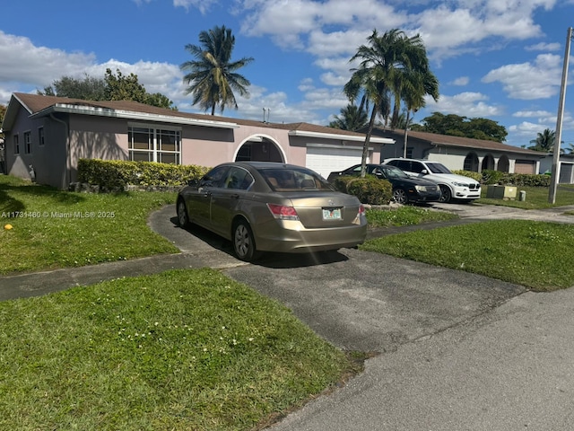 view of front of house with a garage and a front yard