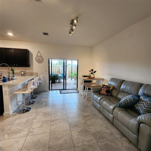 living room with light tile patterned floors and rail lighting