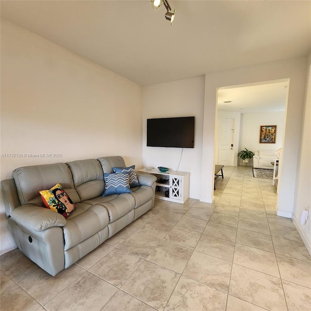 tiled living room with rail lighting