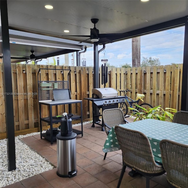 view of patio with area for grilling and ceiling fan