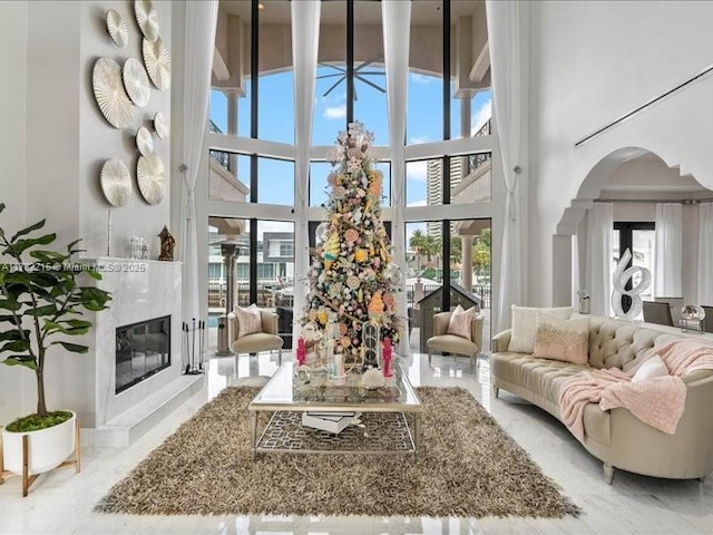 living room featuring a high ceiling and a fireplace