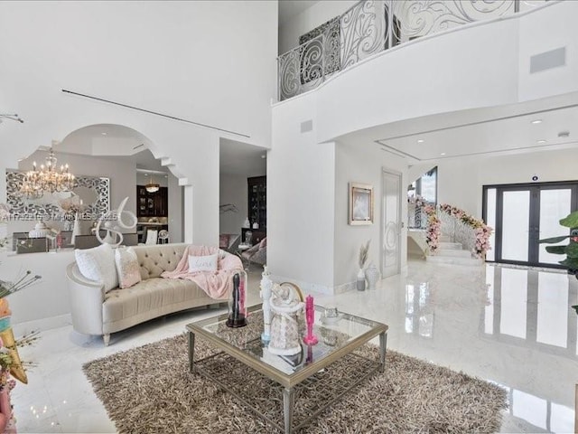 living room with a high ceiling and a notable chandelier