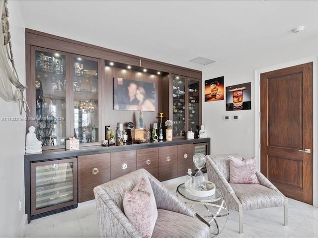 bar with dark brown cabinets and wine cooler