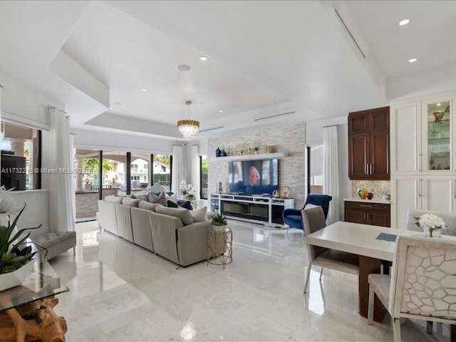 living room featuring an inviting chandelier and a tray ceiling