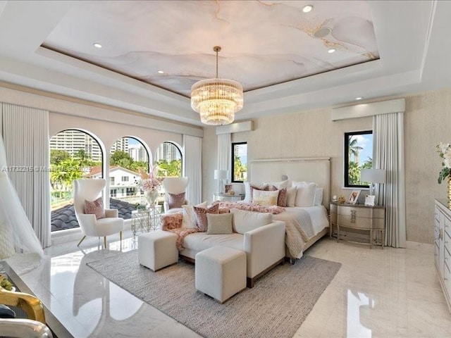 bedroom featuring multiple windows, a notable chandelier, and a tray ceiling