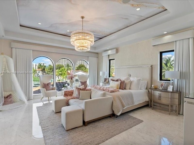 bedroom with a chandelier, access to exterior, and a raised ceiling