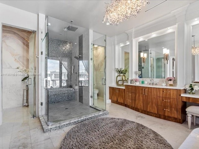 bathroom featuring vanity, an enclosed shower, a chandelier, and toilet