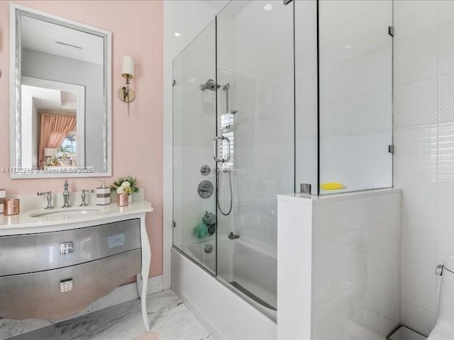 bathroom with vanity and shower / bath combination with glass door