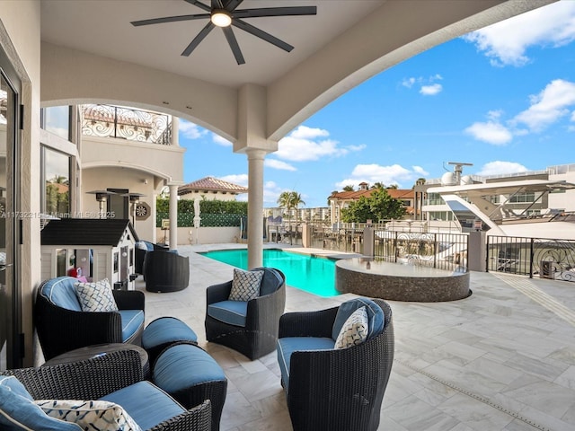 view of pool with ceiling fan, outdoor lounge area, and a patio area