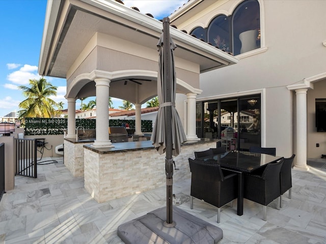 view of patio / terrace featuring an outdoor kitchen and exterior bar