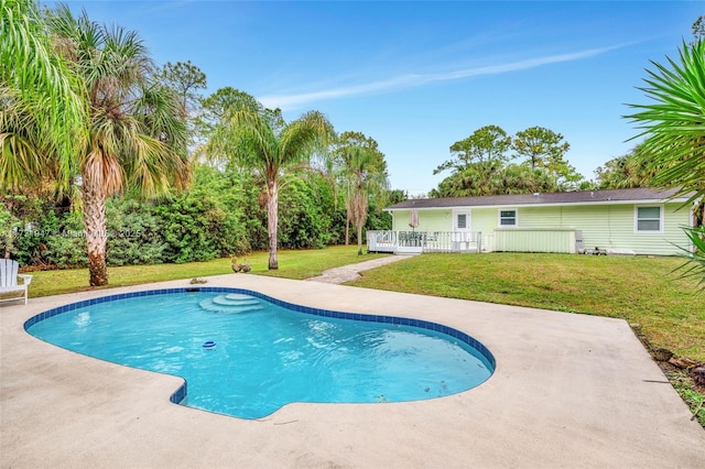 view of pool with a yard, a patio area, and a deck