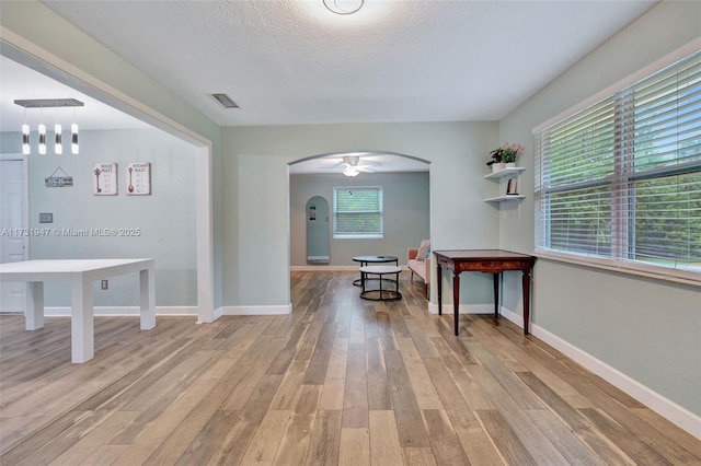 interior space featuring a textured ceiling and light wood-type flooring