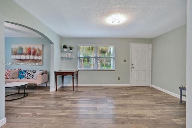 foyer with light hardwood / wood-style flooring and a textured ceiling