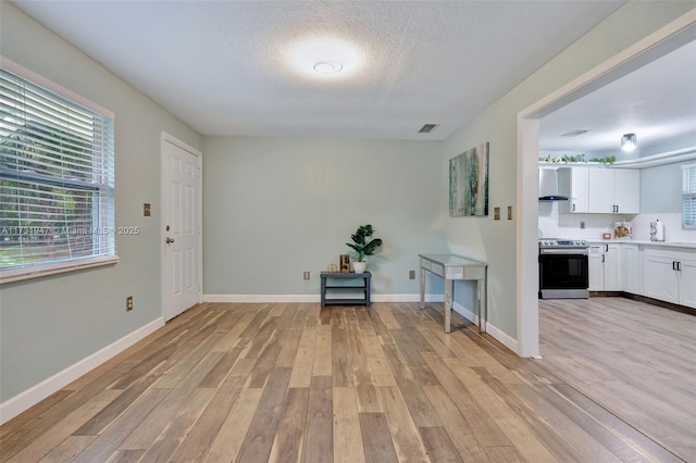 entrance foyer featuring a textured ceiling and light hardwood / wood-style floors