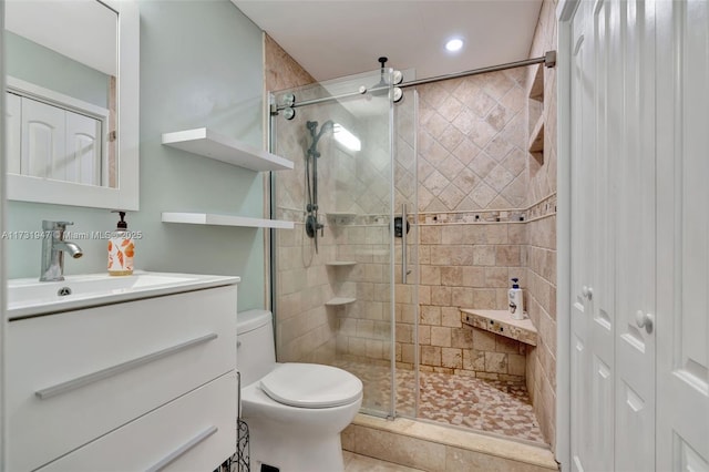 bathroom with vanity, toilet, and walk in shower