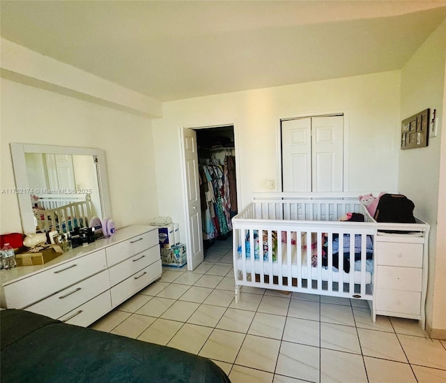 11780 SW 18th St Unit 510-2, Miami, FL 33175 - bedroom with a walk in closet, a closet, and light tile patterned floors