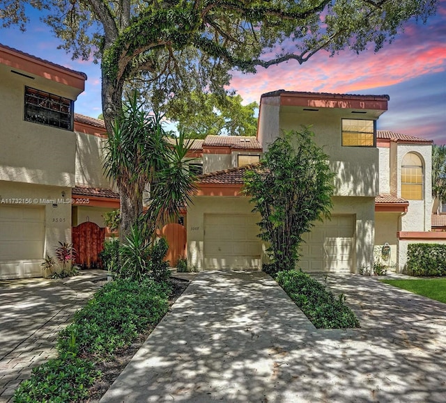 mediterranean / spanish home with a garage