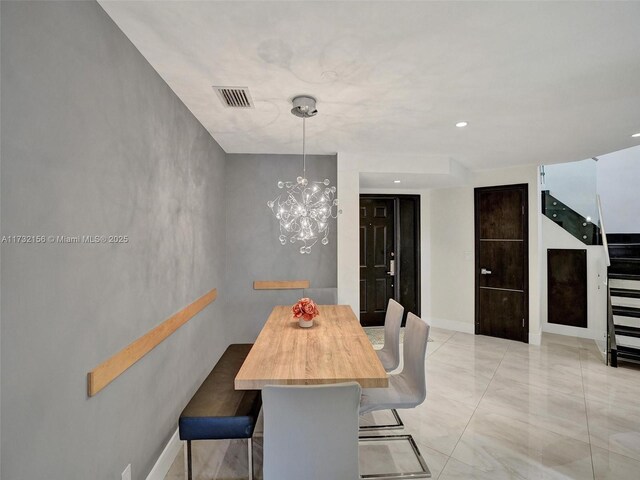 dining area featuring an inviting chandelier