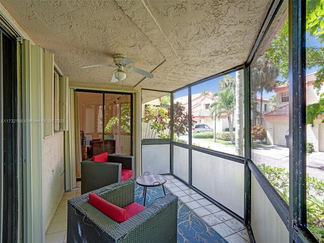 sunroom / solarium featuring ceiling fan