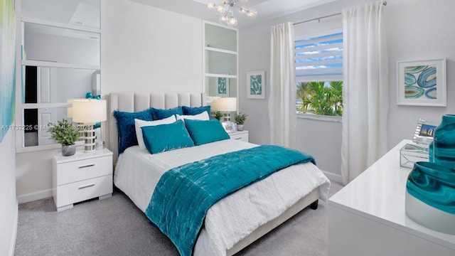 carpeted bedroom with a chandelier