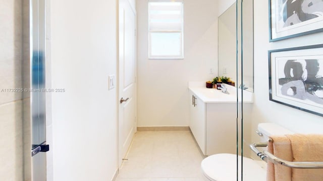 bathroom featuring vanity, tile patterned flooring, and toilet