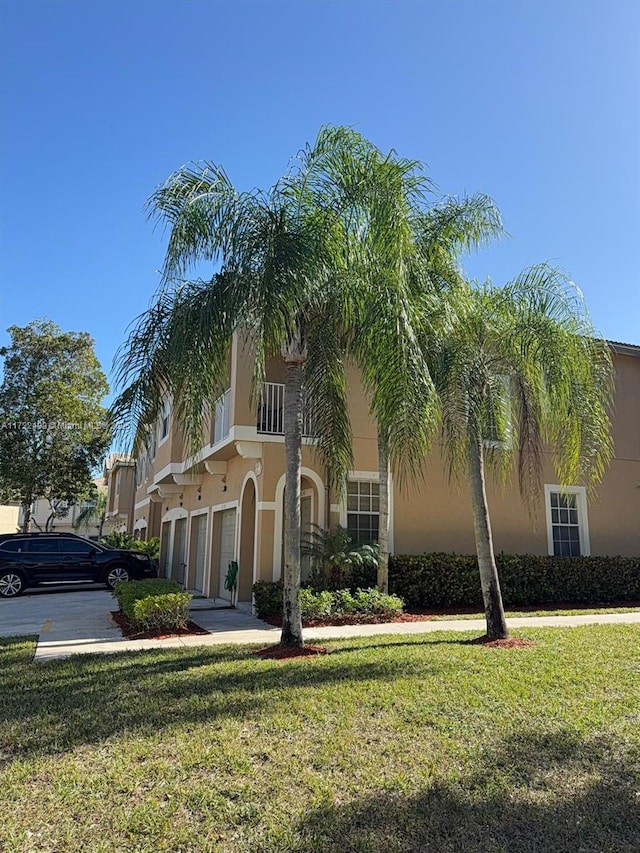 mediterranean / spanish-style house featuring a garage and a front yard