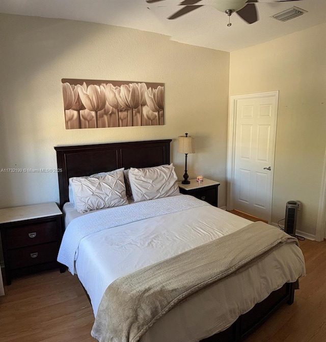 bedroom with hardwood / wood-style flooring and ceiling fan