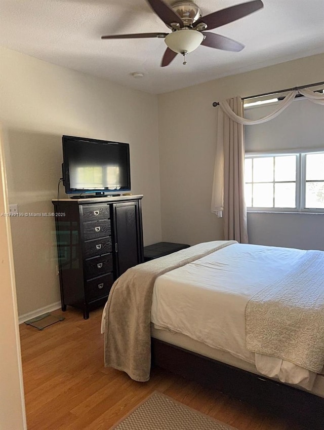 bedroom with hardwood / wood-style flooring and ceiling fan