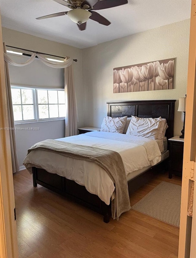 bedroom featuring ceiling fan and hardwood / wood-style floors