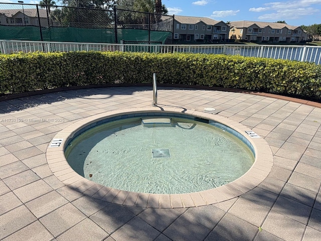 view of swimming pool with a community hot tub