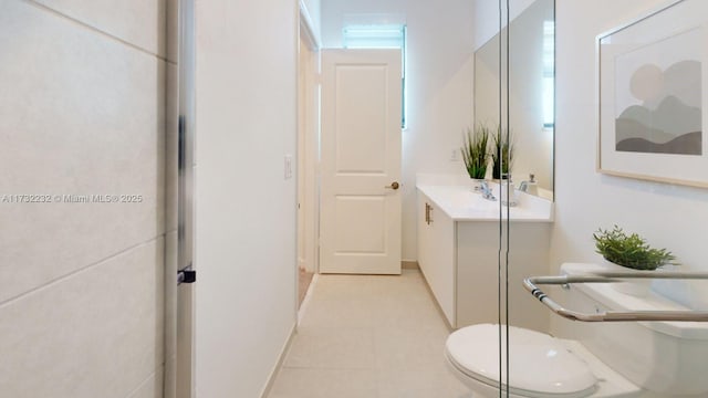 bathroom featuring vanity, tile patterned flooring, and toilet