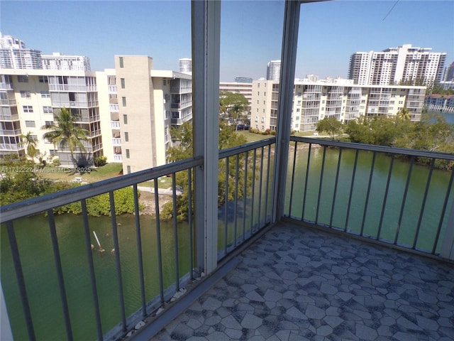 balcony with a view of city and a water view