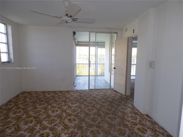 carpeted empty room featuring a ceiling fan and a healthy amount of sunlight