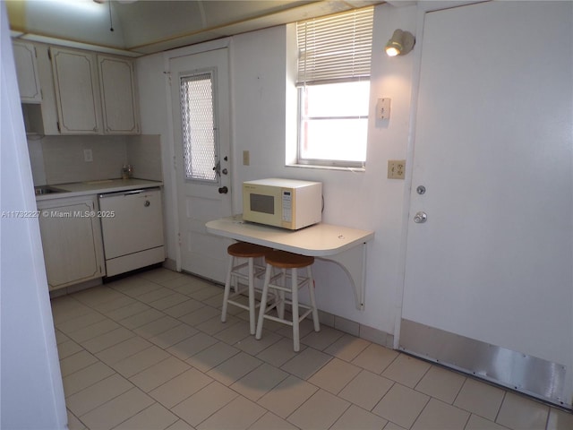 kitchen featuring light countertops, white appliances, and tasteful backsplash