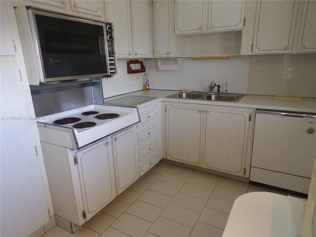 kitchen featuring open shelves, light countertops, decorative backsplash, a sink, and white appliances