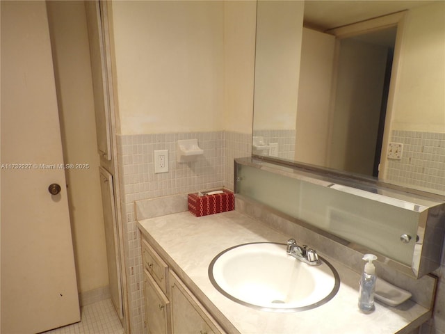 bathroom featuring wainscoting, vanity, tile walls, and tile patterned floors