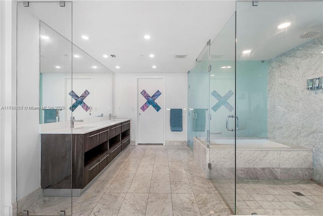 full bathroom with a stall shower, a garden tub, a sink, and double vanity