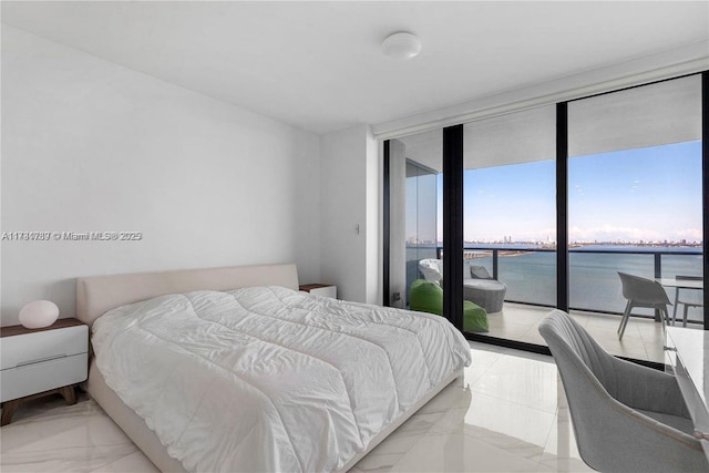 bedroom with access to exterior, expansive windows, marble finish floor, and a water view