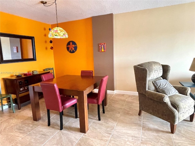 dining space with a textured ceiling