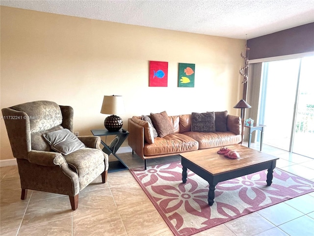 living room featuring a textured ceiling and light tile patterned floors