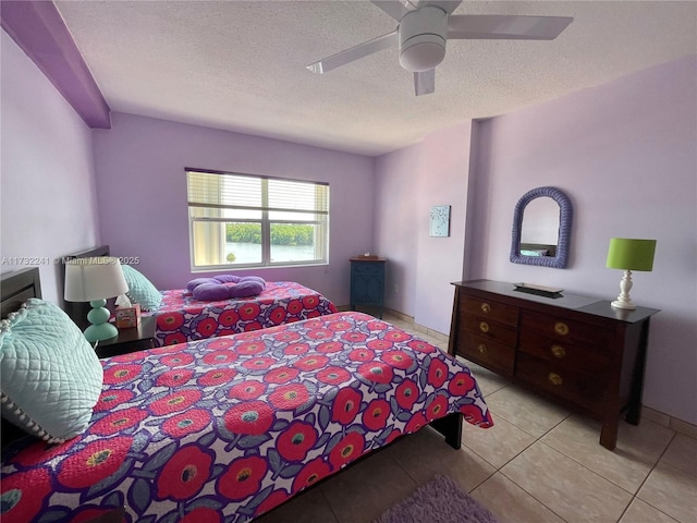 tiled bedroom with a textured ceiling and ceiling fan