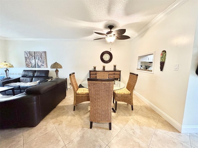 dining space with ornamental molding, light tile patterned flooring, ceiling fan, and a textured ceiling