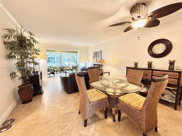 dining room with light tile patterned floors, ornamental molding, a textured ceiling, and ceiling fan