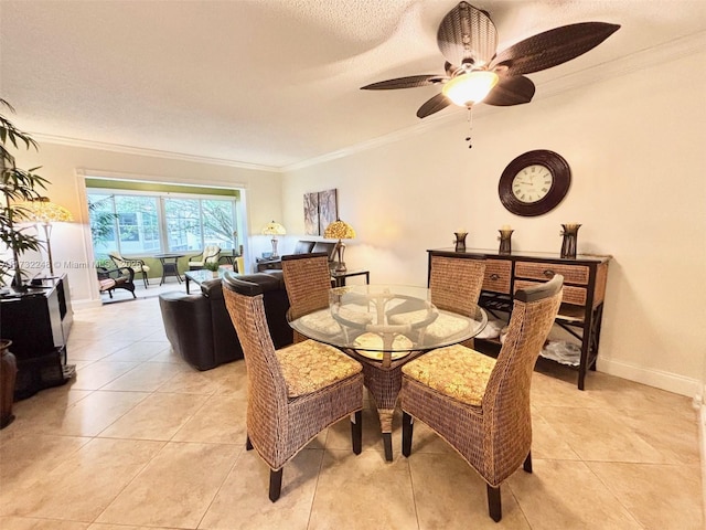 tiled dining area featuring crown molding, ceiling fan, and a textured ceiling