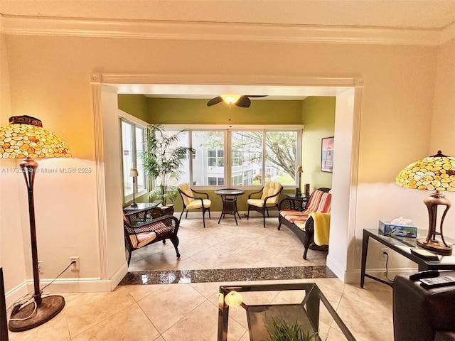 interior space with ceiling fan and ornamental molding