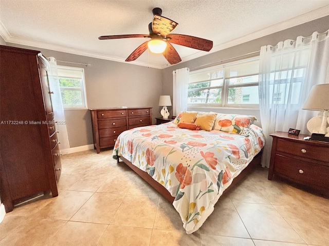 tiled bedroom with ceiling fan, ornamental molding, multiple windows, and a textured ceiling